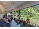 Bright and airy screened porch with string lights and lush greenery views at 2771 Cedaridge Cir, Clermont, FL 34711