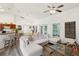 Open concept living room with sectional sofa and view into kitchen at 2771 Cedaridge Cir, Clermont, FL 34711
