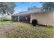 Tan house exterior with a screened porch and grill area at 2771 Cedaridge Cir, Clermont, FL 34711