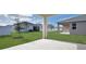 Private backyard with covered patio and grassy area at 4216 Sawtooth Ct, Tavares, FL 32778