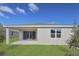 Home exterior showcasing a covered patio and lawn at 4216 Sawtooth Ct, Tavares, FL 32778