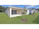 Rear view of house with covered patio and landscaping at 4216 Sawtooth Ct, Tavares, FL 32778