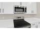 Stainless steel range and microwave in a modern kitchen at 4216 Sawtooth Ct, Tavares, FL 32778