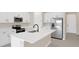 Modern kitchen with white cabinets, stainless steel appliances, and a large island at 4216 Sawtooth Ct, Tavares, FL 32778