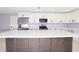 Kitchen island with dark cabinetry and quartz countertop at 10633 Watertown Ct, Orlando, FL 32821
