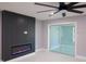Modern linear fireplace with dark gray wall paneling at 10633 Watertown Ct, Orlando, FL 32821