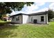 Rear view of house showcasing updated exterior and landscaping at 10633 Watertown Ct, Orlando, FL 32821