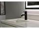 Modern bathroom sink with sleek black faucet and white countertop at 10633 Watertown Ct, Orlando, FL 32821