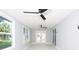 Bright sunroom featuring two ceiling fans and sliding glass doors at 10633 Watertown Ct, Orlando, FL 32821