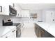 Modern kitchen with stainless steel appliances and white cabinets at 10633 Watertown Ct, Orlando, FL 32821