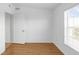 Bright bedroom with wood floors, large window, and door to hallway at 3301 Whitestone Cir # 308, Kissimmee, FL 34741