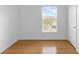 Simple bedroom with light wood floors and a large window at 3301 Whitestone Cir # 308, Kissimmee, FL 34741