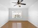Spacious bedroom with ceiling fan, large window, and wood floors at 3301 Whitestone Cir # 308, Kissimmee, FL 34741