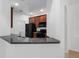 Modern kitchen with dark wood cabinets and granite countertops at 3301 Whitestone Cir # 308, Kissimmee, FL 34741