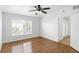 Bedroom with wood floors, large window, and access to balcony at 3301 Whitestone Cir # 308, Kissimmee, FL 34741