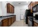 Well-equipped kitchen featuring dark wood cabinets and black appliances at 3301 Whitestone Cir # 308, Kissimmee, FL 34741