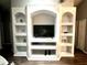Built-in entertainment center with ample shelving and space for a large TV at 2556 Bear Creek Ct, Kissimmee, FL 34747