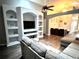 Open concept living area with a large sectional sofa and entertainment center at 2556 Bear Creek Ct, Kissimmee, FL 34747