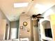 Bright living room with vaulted ceilings, skylights, and a ceiling fan at 2556 Bear Creek Ct, Kissimmee, FL 34747