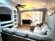 Open concept living room with a sectional sofa and built-in shelving at 2556 Bear Creek Ct, Kissimmee, FL 34747