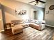 Relaxing living room featuring a large sectional sofa and wood floors at 2556 Bear Creek Ct, Kissimmee, FL 34747