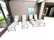 Four lounge chairs on the pool deck with a propane grill nearby at 2556 Bear Creek Ct, Kissimmee, FL 34747