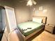 Bedroom with a full-size bed, patio door and neutral decor at 2556 Bear Creek Ct, Kissimmee, FL 34747