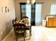 Bright dining area with curtains and a six-chair table at 2556 Bear Creek Ct, Kissimmee, FL 34747