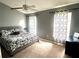 Bright bedroom featuring a king-size bed and patterned bedding at 2556 Bear Creek Ct, Kissimmee, FL 34747
