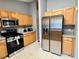 Kitchen with stainless steel appliances and wood cabinets at 2556 Bear Creek Ct, Kissimmee, FL 34747