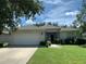 One-story house with attached garage and green lawn at 4311 Sw 53Rd Ter, Ocala, FL 34474