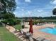 Relaxing community pool with lounge chairs and playground at 4311 Sw 53Rd Ter, Ocala, FL 34474