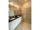 Double vanity bathroom with granite counters and glass shower at 166 Captiva Dr, Davenport, FL 33896