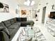 Living area featuring a sectional sofa, coffee table, and view into dining area at 457 Prestwick Pl # 457, Kissimmee, FL 34759