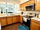 A kitchen with wood cabinets, stainless steel appliances, and granite countertops at 457 Prestwick Pl # 457, Kissimmee, FL 34759