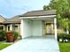 Front view of a house with carport, landscaping, and a paved driveway at 457 Prestwick Pl # 457, Kissimmee, FL 34759