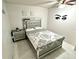 Bedroom with a queen-size bed, nightstand, and decorative wall art at 457 Prestwick Pl # 457, Kissimmee, FL 34759