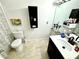Bathroom with a toilet, vanity with sink, and shower/tub combo at 457 Prestwick Pl # 457, Kissimmee, FL 34759