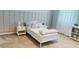 Cozy bedroom with a twin bed, neutral wall decor, and built-in shelving at 13706 Werrington Dr, Winter Garden, FL 34787