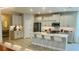 Modern kitchen with island, stainless steel appliances, and white quartz countertops at 13706 Werrington Dr, Winter Garden, FL 34787