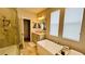 Modern bathroom with a soaking tub, walk-in shower, and dual sinks at 13706 Werrington Dr, Winter Garden, FL 34787