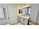 Bright bathroom boasts a vanity with quartz countertop and an updated door at 13706 Werrington Dr, Winter Garden, FL 34787