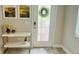 Bright entryway with white console table, artwork, and wreath on door at 13706 Werrington Dr, Winter Garden, FL 34787