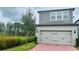 Two-story home with attached garage and neatly landscaped front yard at 13706 Werrington Dr, Winter Garden, FL 34787