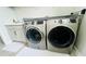 Modern laundry room with updated washer and dryer and built in cabinetry at 13706 Werrington Dr, Winter Garden, FL 34787