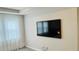 Bedroom with mounted TV and large window with sheer curtains at 13706 Werrington Dr, Winter Garden, FL 34787