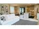 Open concept living room with white couch, kitchen view, and black and white rug at 13706 Werrington Dr, Winter Garden, FL 34787