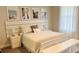 Bright bedroom with white bed, bench, and framed travel photography at 13706 Werrington Dr, Winter Garden, FL 34787