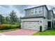 Two-story home with attached garage and brick paver driveway at 13706 Werrington Dr, Winter Garden, FL 34787