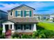 Two-story home with gray siding, teal shutters, and a landscaped front yard at 13706 Werrington Dr, Winter Garden, FL 34787
